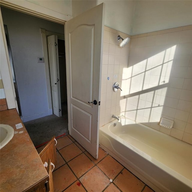 bathroom featuring tile patterned flooring, vanity, and bathing tub / shower combination