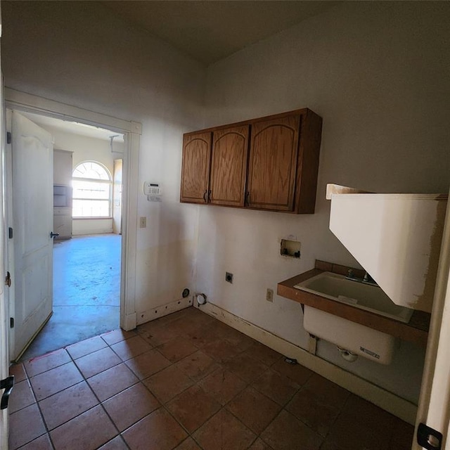 washroom with cabinets, sink, hookup for a washing machine, tile patterned flooring, and hookup for an electric dryer