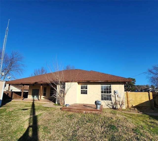 rear view of property featuring a yard and a patio