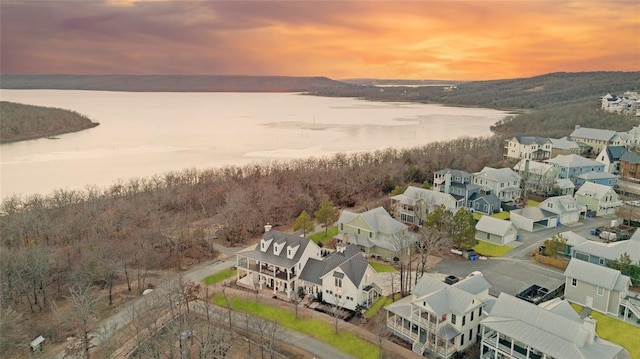 birds eye view of property featuring a water view and a residential view