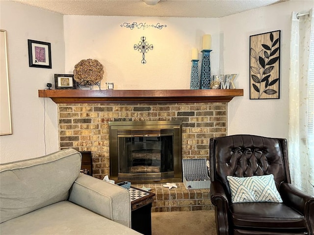 sitting room featuring a textured ceiling and a brick fireplace