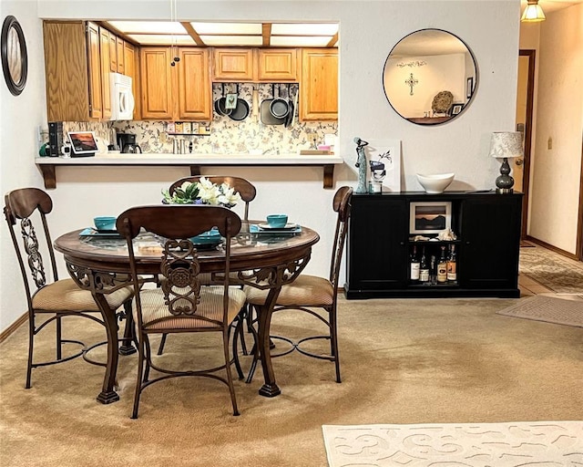 kitchen with light carpet and kitchen peninsula