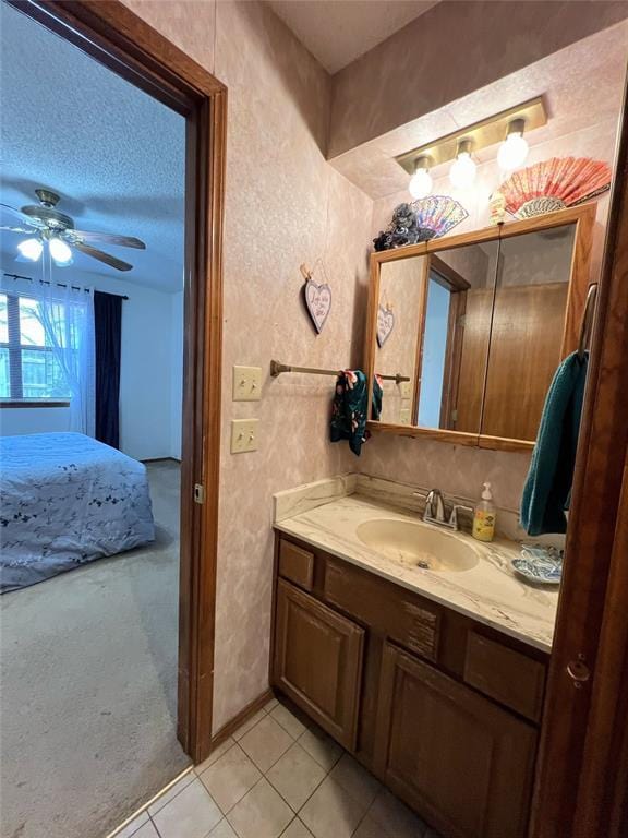 bathroom featuring a textured ceiling, ceiling fan, tile patterned flooring, and vanity