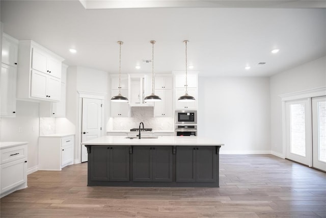9237 NW 86th St, Yukon, OK 73099 - kitchen with oven, built in microwave, recessed lighting, white cabinetry, and backsplash