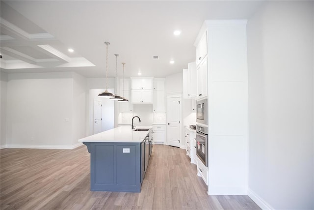 9237 NW 86th St, Yukon, OK 73099 - kitchen with stainless steel appliances, white cabinets, recessed lighting, a center island with sink, and light wood-style floors