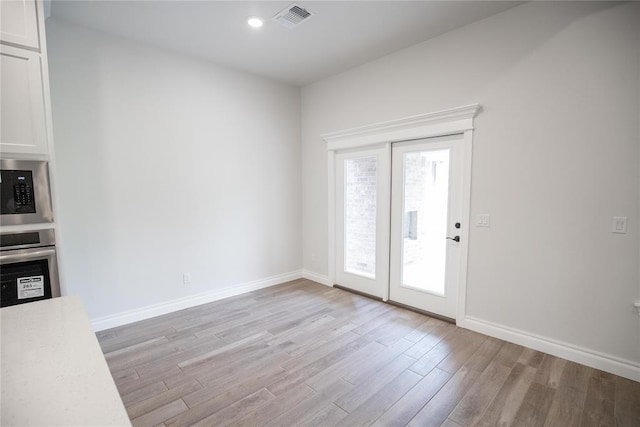 9237 NW 86th St, Yukon, OK 73099 - unfurnished dining area with light wood-style floors and recessed lighting