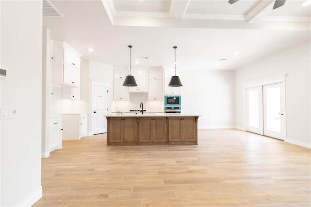 11813 Ethan Mark Dr, Yukon, OK 73099 - kitchen featuring built in microwave, stainless steel oven, light wood-style floors, light countertops, and recessed lighting