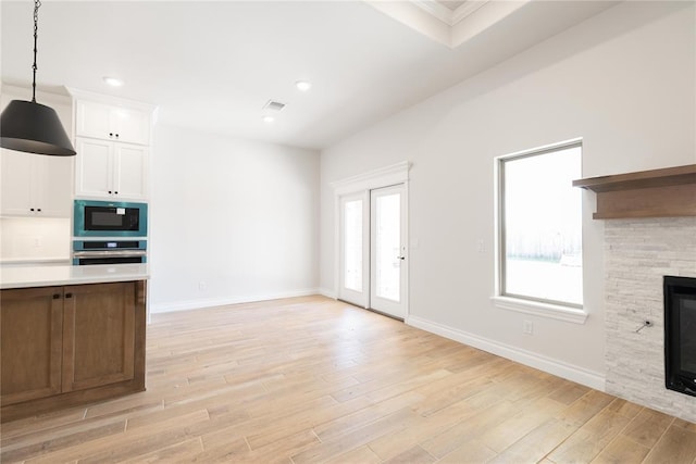 11813 Ethan Mark Dr, Yukon, OK 73099 - unfurnished living room with light wood-type flooring, a fireplace, baseboards, recessed lighting, and crown molding