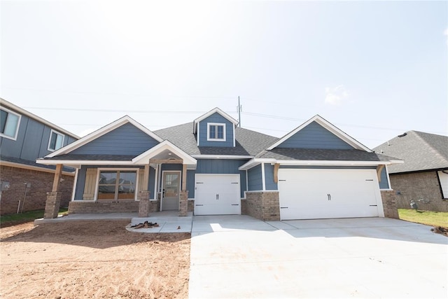11813 Ethan Mark Dr, Yukon, OK 73099 - craftsman house featuring a garage, brick siding, roof with shingles, and concrete driveway