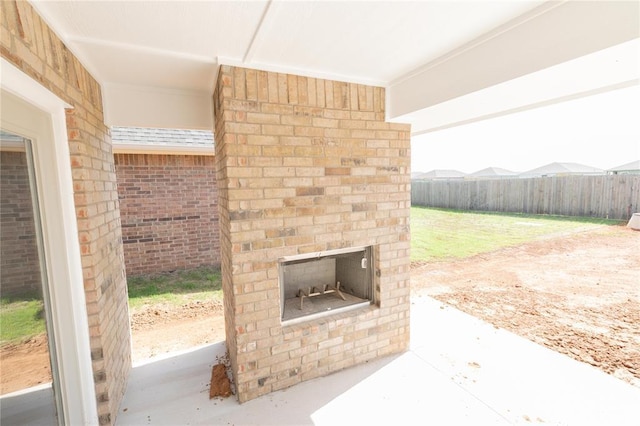 11813 Ethan Mark Dr, Yukon, OK 73099 - view of patio / terrace with an outdoor brick fireplace
