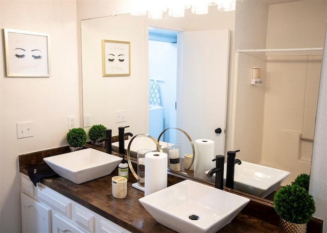 bathroom with walk in shower and vanity