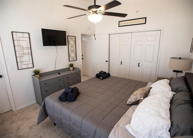 carpeted bedroom featuring a closet and ceiling fan