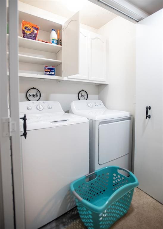 laundry area with cabinets and washing machine and clothes dryer