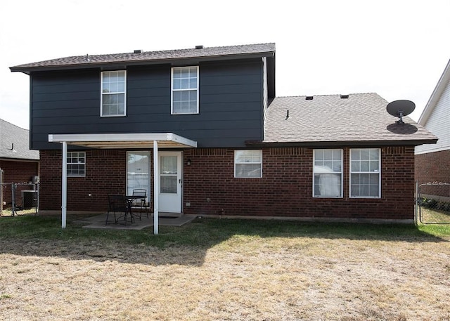 back of house featuring a lawn and a patio