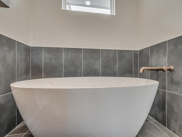 bathroom featuring tile patterned flooring and a bathing tub