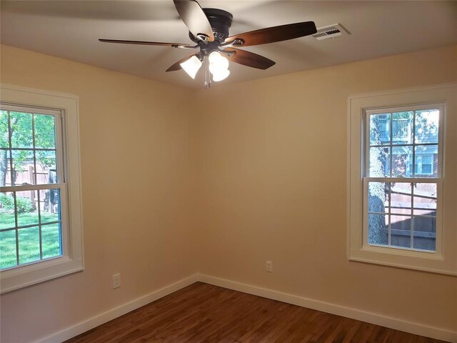 1021 W Apache St, Norman, OK 73069 - spare room with plenty of natural light, baseboards, and dark wood-type flooring
