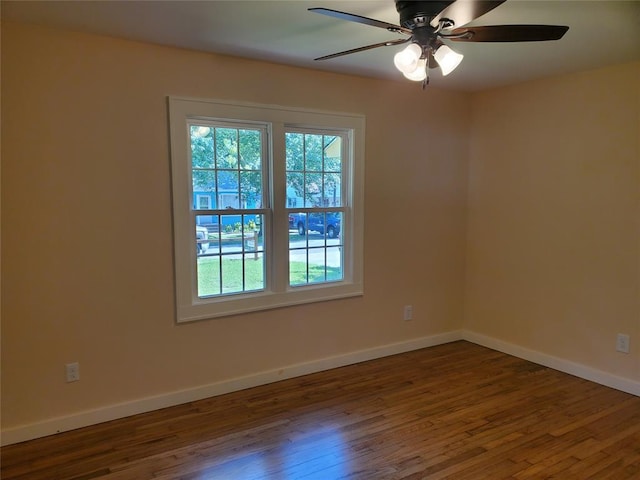 1021 W Apache St, Norman, OK 73069 - unfurnished room with dark wood-type flooring, a ceiling fan, and baseboards