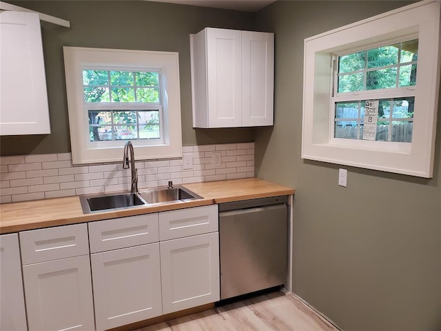 1021 W Apache St, Norman, OK 73069 - kitchen featuring butcher block counters, stainless steel dishwasher, and plenty of natural light