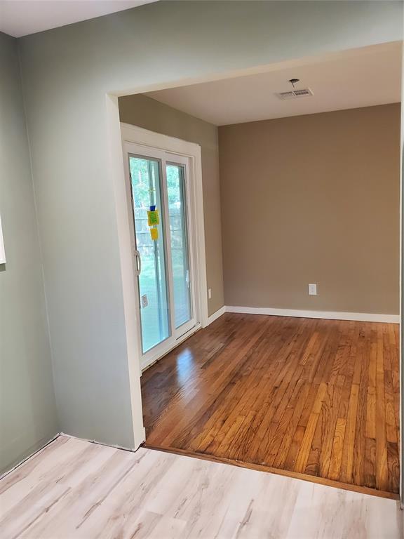 1021 W Apache St, Norman, OK 73069 - spare room featuring wood finished floors and baseboards