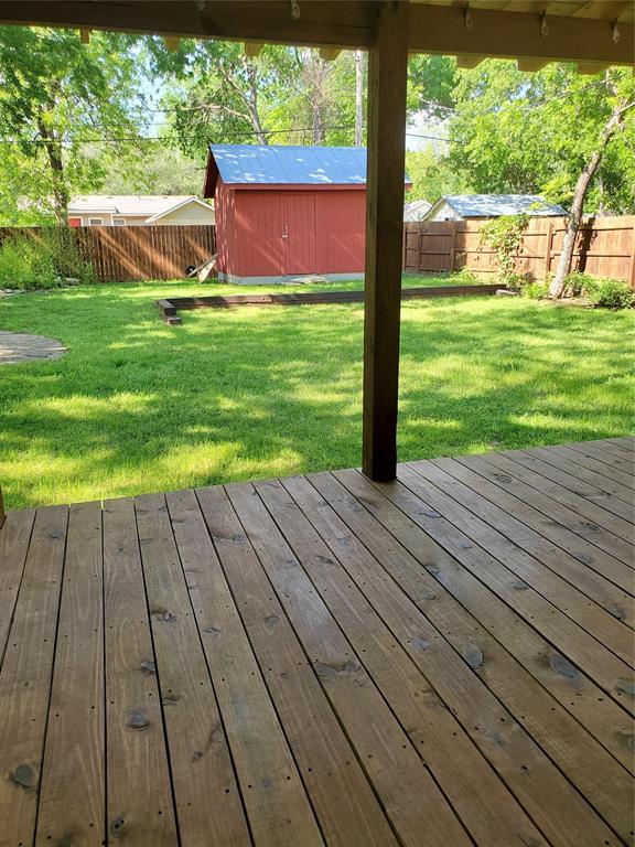 1021 W Apache St, Norman, OK 73069 - wooden deck with a storage unit and an outdoor structure