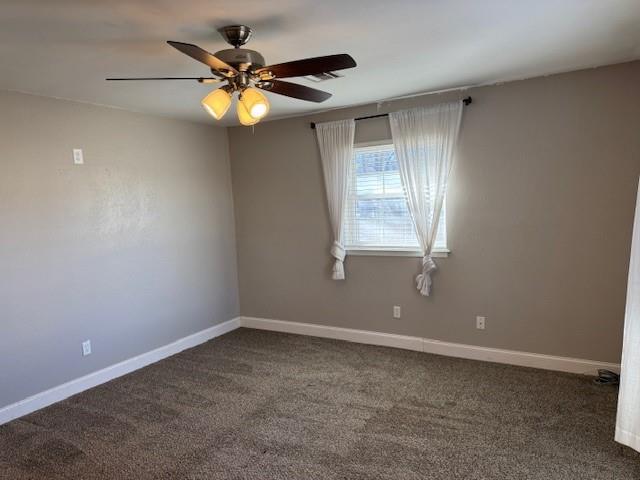 spare room featuring carpet floors, baseboards, and a ceiling fan