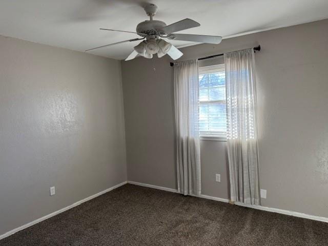 carpeted spare room featuring ceiling fan and baseboards