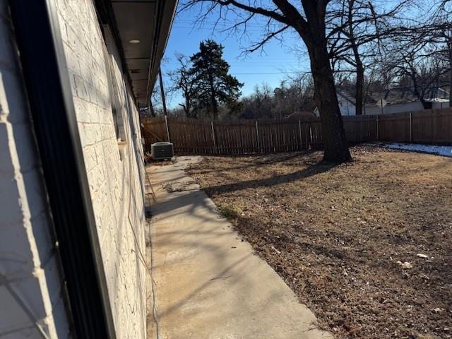 view of yard with cooling unit and a fenced backyard