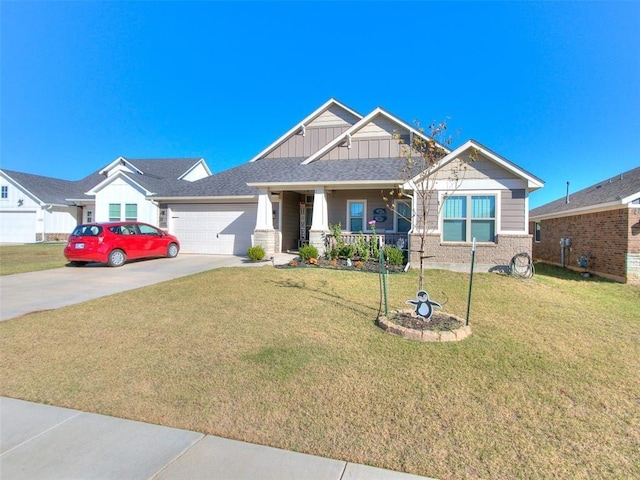 view of front of house with a front lawn, covered porch, and a garage