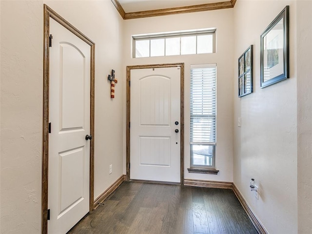 foyer entrance with dark hardwood / wood-style flooring and crown molding