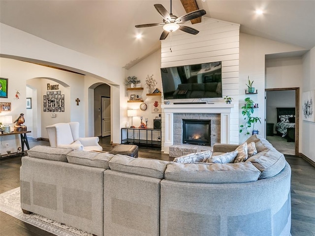 living room with ceiling fan, beamed ceiling, dark wood-type flooring, and high vaulted ceiling