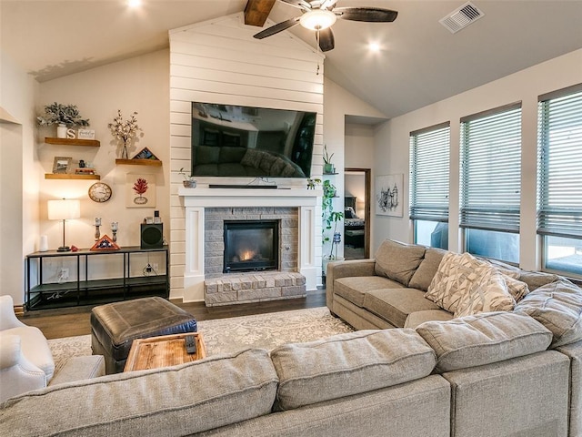 living room with a fireplace, wood-type flooring, vaulted ceiling with beams, and ceiling fan