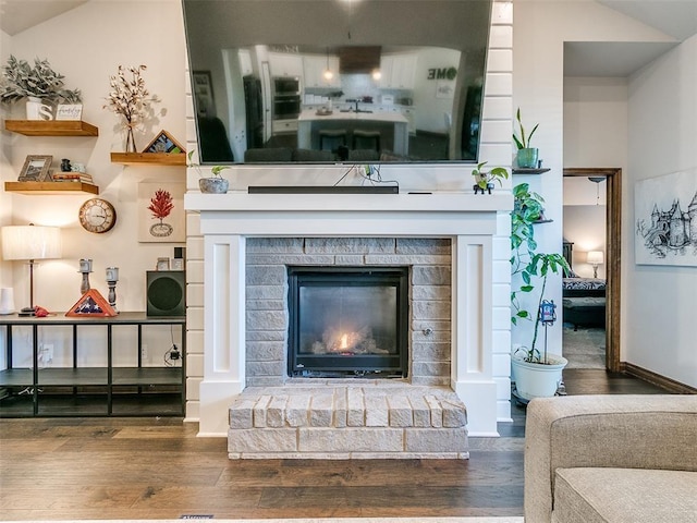 room details with a fireplace and wood-type flooring