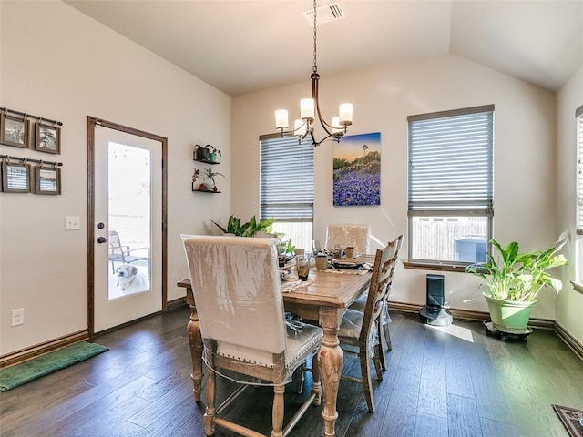 dining space with a wealth of natural light, dark hardwood / wood-style flooring, lofted ceiling, and a notable chandelier