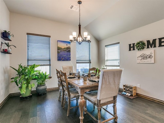 dining area with dark wood-type flooring, vaulted ceiling, plenty of natural light, and a notable chandelier