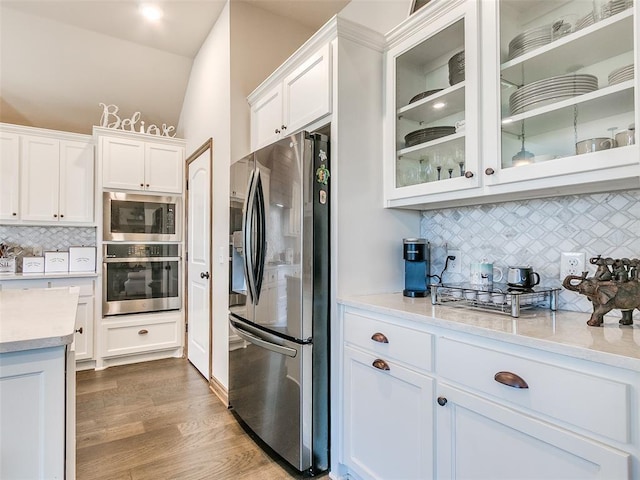 kitchen featuring white cabinetry, backsplash, and appliances with stainless steel finishes