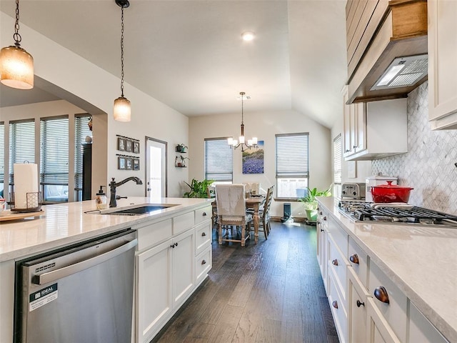 kitchen with pendant lighting, sink, white cabinets, and stainless steel appliances