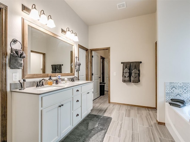 bathroom featuring vanity and a tub