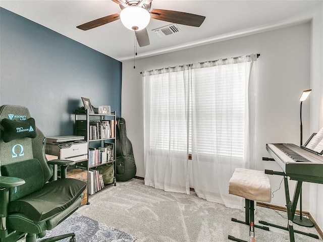 carpeted office space with ceiling fan