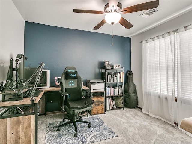 carpeted office featuring ceiling fan and a wealth of natural light