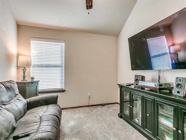 carpeted living room with lofted ceiling