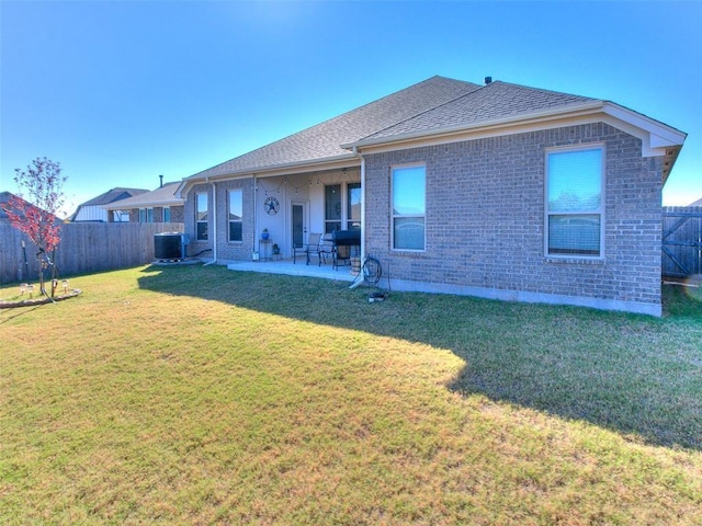 back of property featuring a lawn, a patio area, and central AC