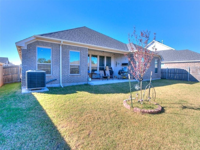 back of property featuring a patio area, a yard, and cooling unit