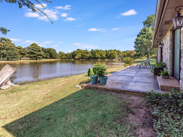 view of yard featuring a patio area and a water view