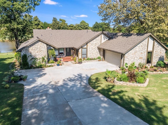 2207 Lake Front Cir, Norman, OK 73069 - mid-century modern home featuring stone siding, concrete driveway, an attached garage, a front lawn, and roof with shingles