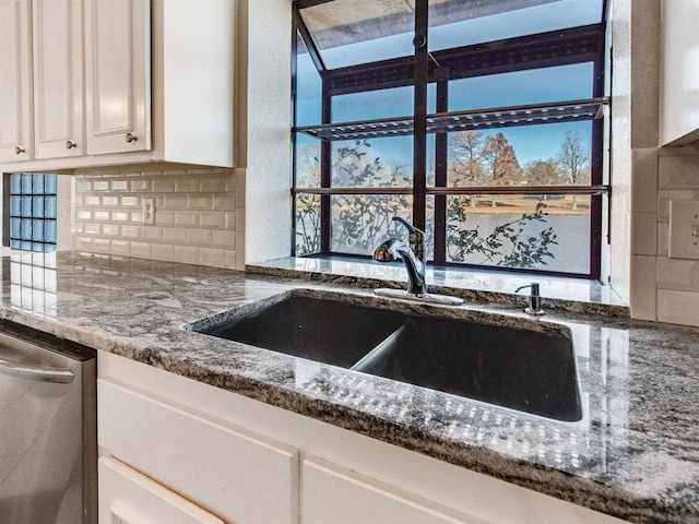 2207 Lake Front Cir, Norman, OK 73069 - kitchen featuring stainless steel dishwasher, tasteful backsplash, dark stone countertops, and white cabinets