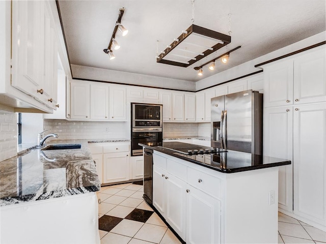 2207 Lake Front Cir, Norman, OK 73069 - kitchen featuring stainless steel appliances, rail lighting, light tile patterned floors, decorative backsplash, and a center island
