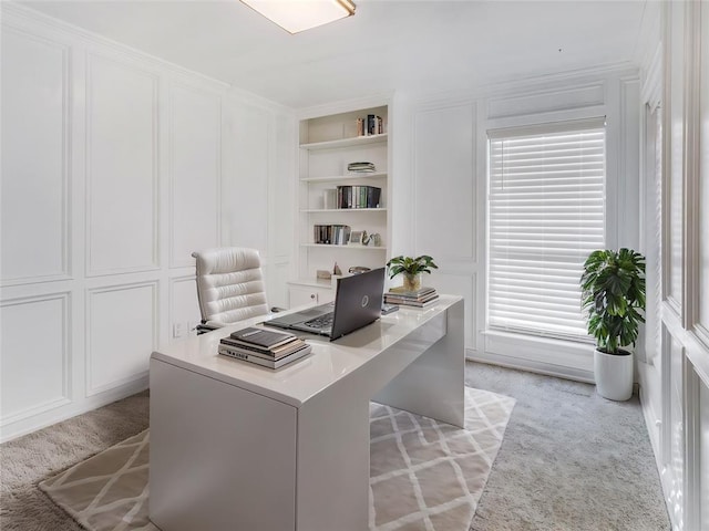 office area featuring light carpet and built in features