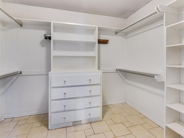 2207 Lake Front Cir, Norman, OK 73069 - spacious closet featuring stone tile flooring