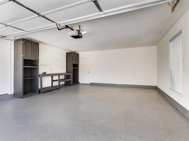 2207 Lake Front Cir, Norman, OK 73069 - garage featuring a garage door opener and baseboards