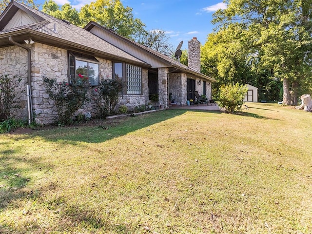 2207 Lake Front Cir, Norman, OK 73069 - view of side of property featuring stone siding, a chimney, a patio, and a yard